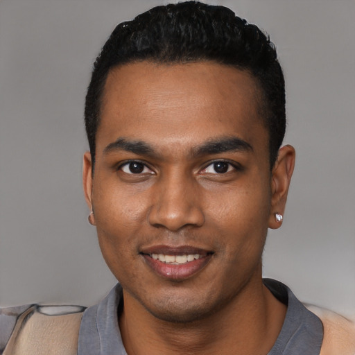 Joyful black young-adult male with short  black hair and brown eyes
