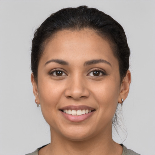 Joyful latino young-adult female with short  brown hair and brown eyes