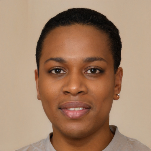 Joyful black young-adult female with short  black hair and brown eyes