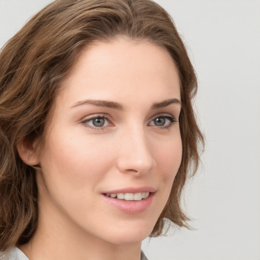 Joyful white young-adult female with medium  brown hair and green eyes