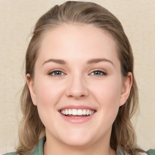 Joyful white young-adult female with long  brown hair and green eyes