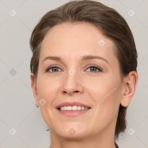 Joyful white young-adult female with medium  brown hair and grey eyes