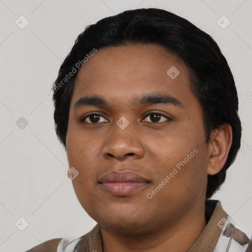 Joyful black young-adult male with short  black hair and brown eyes