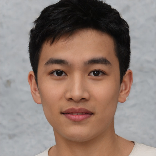 Joyful asian young-adult male with short  black hair and brown eyes