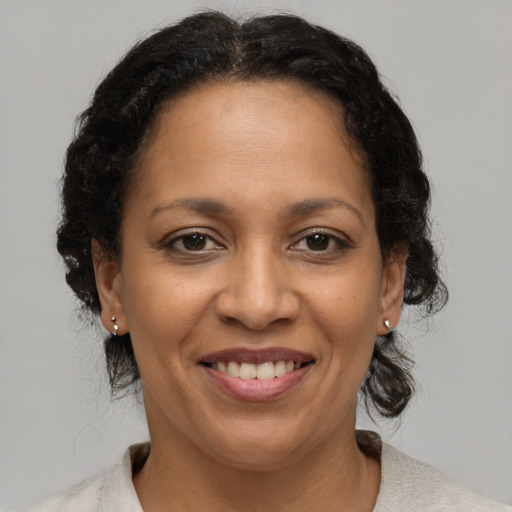 Joyful latino adult female with medium  brown hair and brown eyes