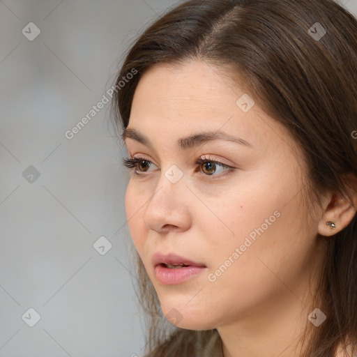 Neutral white young-adult female with long  brown hair and brown eyes