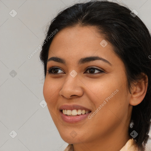 Joyful latino young-adult female with medium  brown hair and brown eyes