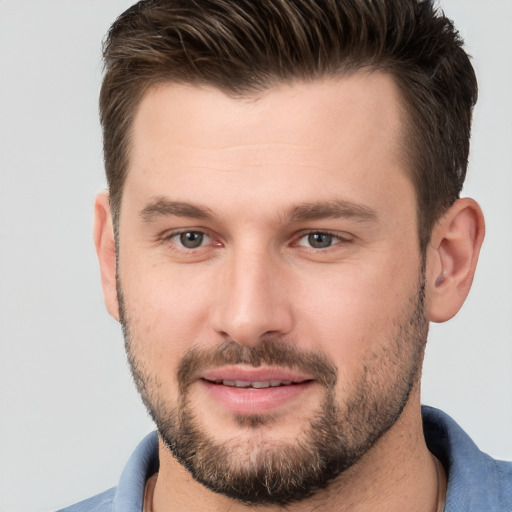 Joyful white young-adult male with short  brown hair and brown eyes