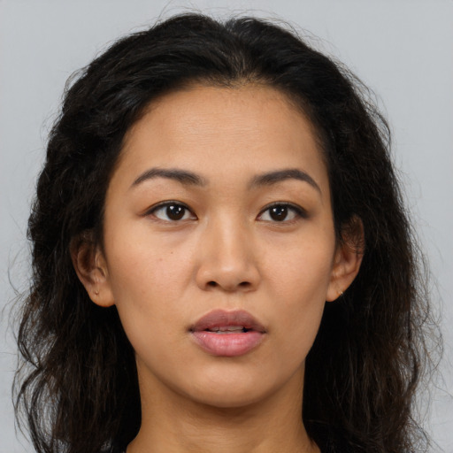 Neutral latino young-adult female with long  brown hair and brown eyes