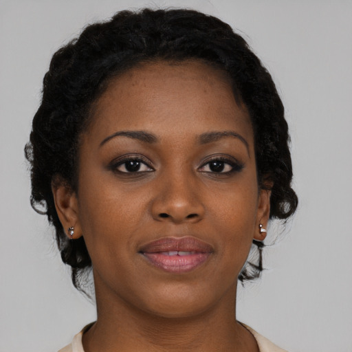 Joyful black young-adult female with medium  black hair and brown eyes
