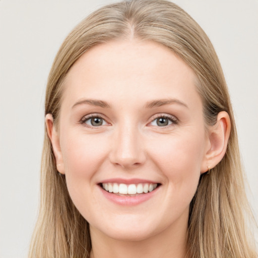 Joyful white young-adult female with long  brown hair and grey eyes