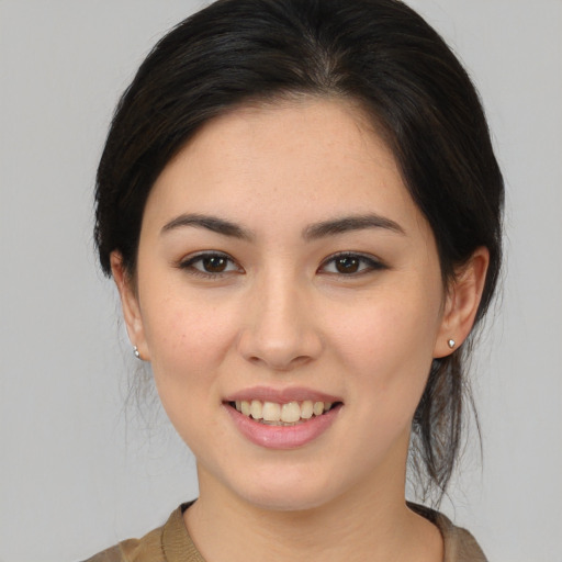 Joyful asian young-adult female with medium  brown hair and brown eyes