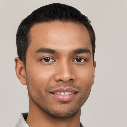 Joyful latino young-adult male with short  brown hair and brown eyes