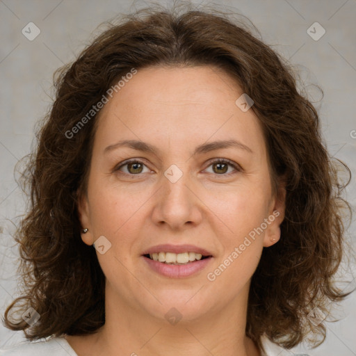 Joyful white adult female with medium  brown hair and green eyes