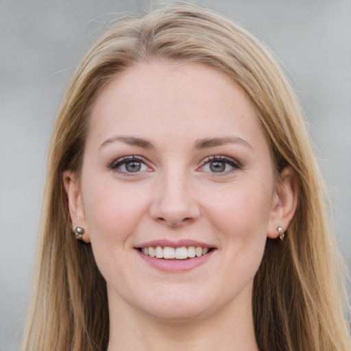 Joyful white young-adult female with long  brown hair and blue eyes