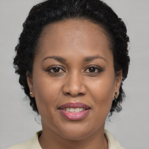 Joyful latino adult female with medium  brown hair and brown eyes