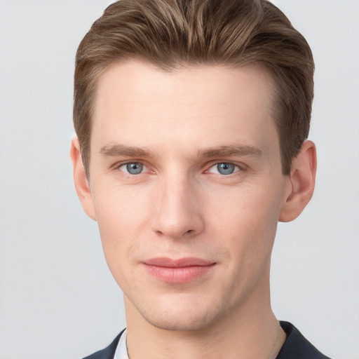 Joyful white young-adult male with short  brown hair and grey eyes