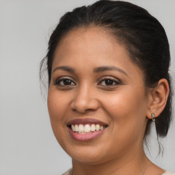 Joyful latino young-adult female with medium  brown hair and brown eyes