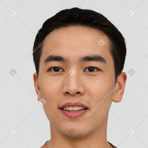 Joyful asian young-adult male with short  black hair and brown eyes