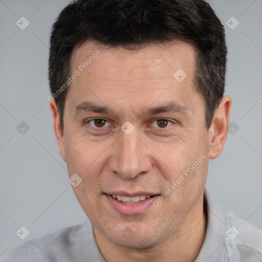 Joyful white adult male with short  brown hair and brown eyes