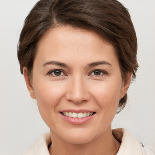 Joyful white young-adult female with short  brown hair and brown eyes