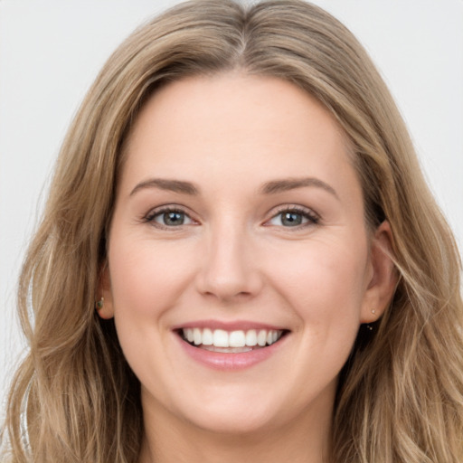 Joyful white young-adult female with long  brown hair and green eyes