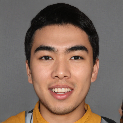 Joyful asian young-adult male with short  black hair and brown eyes