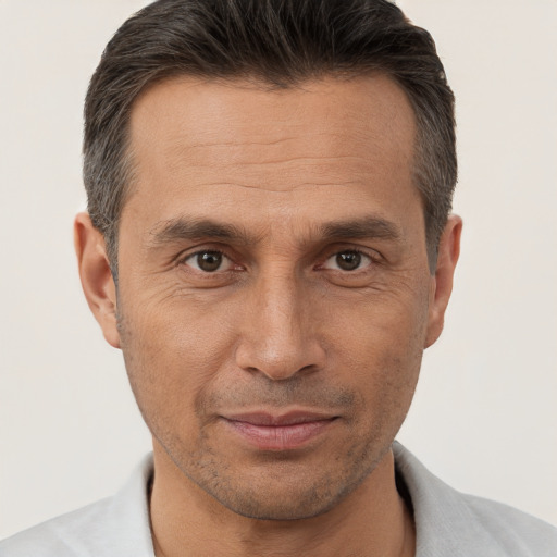 Joyful white adult male with short  brown hair and brown eyes