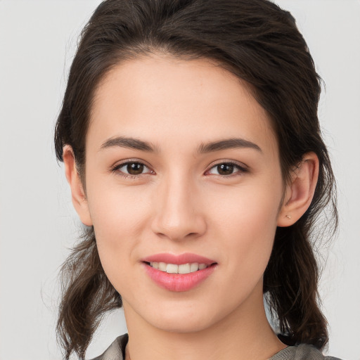 Joyful white young-adult female with medium  brown hair and brown eyes