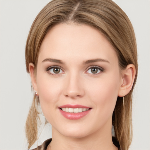 Joyful white young-adult female with long  brown hair and grey eyes