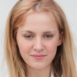 Joyful white young-adult female with long  brown hair and blue eyes