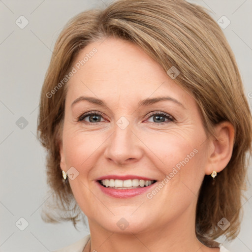 Joyful white adult female with medium  brown hair and grey eyes