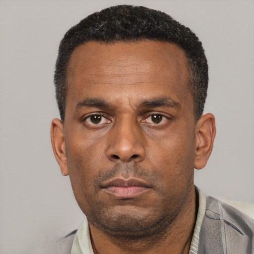 Neutral latino adult male with short  black hair and brown eyes