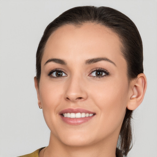 Joyful white young-adult female with long  brown hair and brown eyes