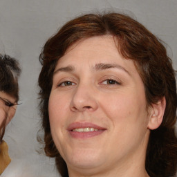 Joyful white adult female with medium  brown hair and brown eyes