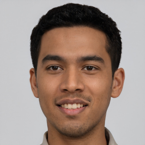 Joyful latino young-adult male with short  black hair and brown eyes