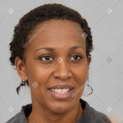 Joyful black adult female with short  brown hair and brown eyes