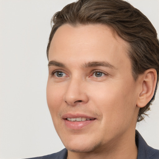 Joyful white adult male with short  brown hair and brown eyes