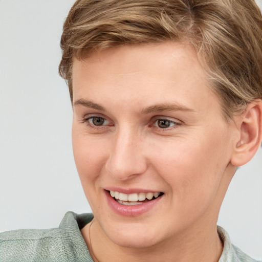 Joyful white young-adult female with short  brown hair and grey eyes