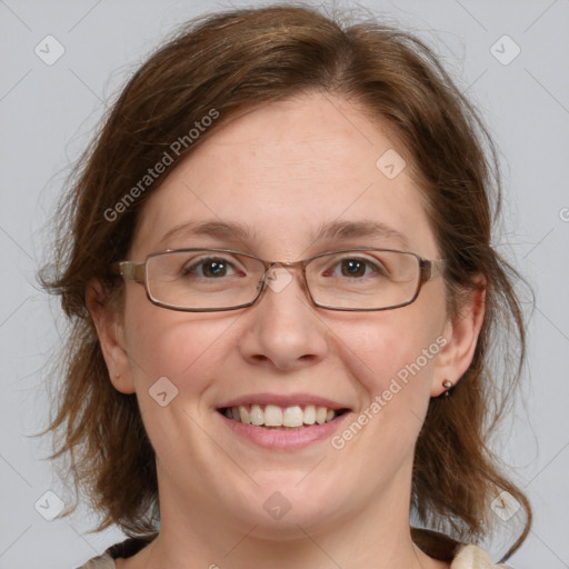 Joyful white adult female with medium  brown hair and blue eyes