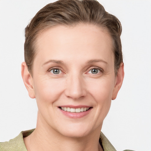 Joyful white young-adult female with short  brown hair and grey eyes