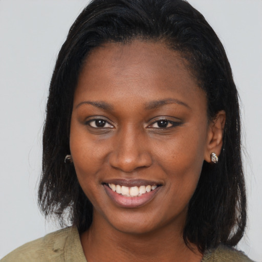 Joyful black young-adult female with long  brown hair and brown eyes