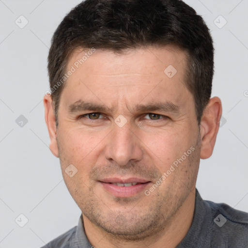 Joyful white adult male with short  brown hair and brown eyes