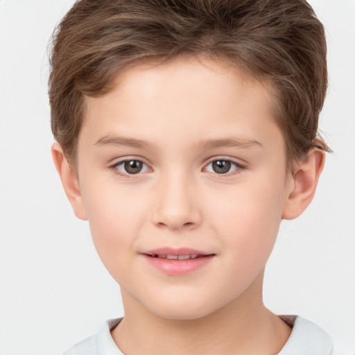 Joyful white child male with short  brown hair and brown eyes