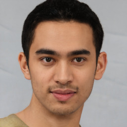 Joyful latino young-adult male with short  brown hair and brown eyes