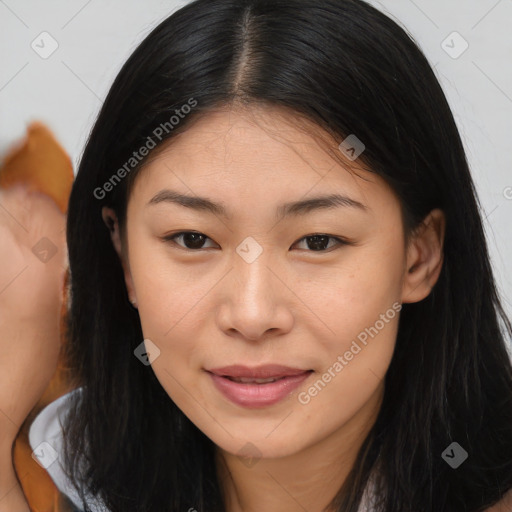 Joyful asian young-adult female with long  brown hair and brown eyes