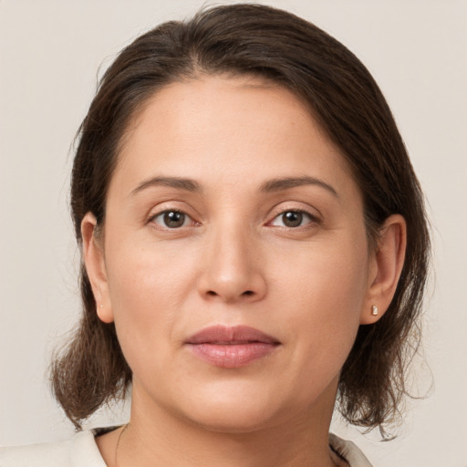 Joyful white young-adult female with medium  brown hair and brown eyes