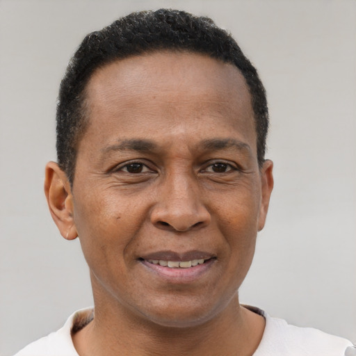 Joyful latino adult male with short  brown hair and brown eyes