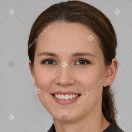 Joyful white young-adult female with medium  brown hair and grey eyes