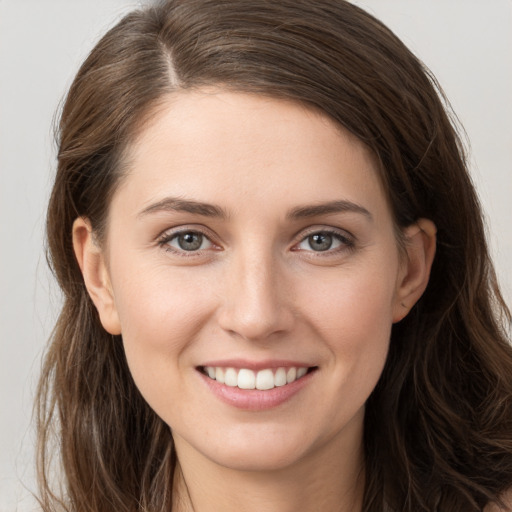 Joyful white young-adult female with long  brown hair and grey eyes